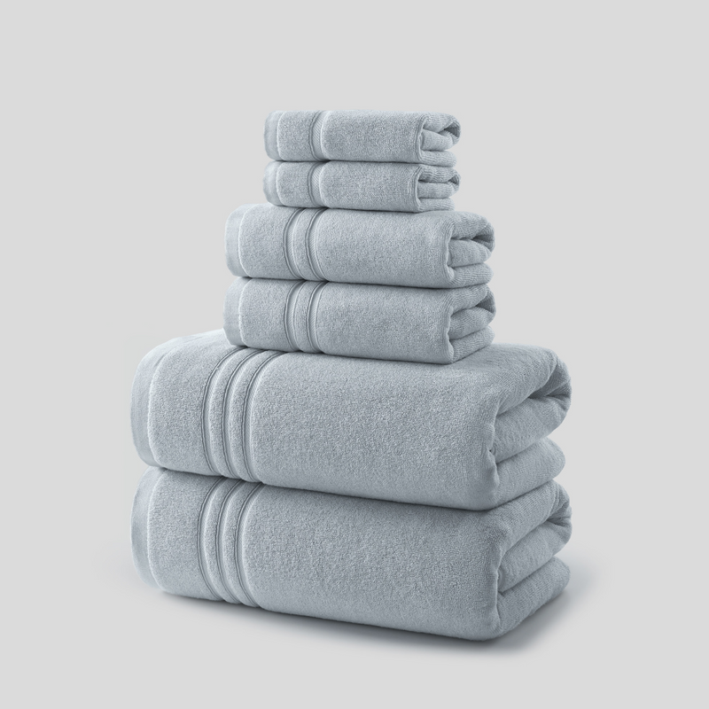 REDKISS light grey 6-piece 100% cotton towel set with 2 bath towels, 2 hand towels and 2 washcloths, neatly stacked to show the solid light grey color, soft terry texture and decorative woven borders. #color_grey